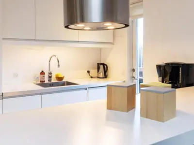 a kitchen with white countertops and a sink and a sink at 6 person holiday home in Blokhus
