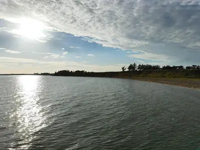 a large body of water with the sun in the sky at 6 person holiday home in Øster Assels in Øster Assels