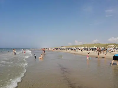 a group of people on a beach with the ocean at Welcoming 6 person holiday home in Blokhus in Blokhus