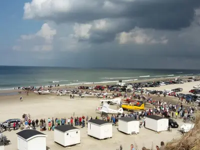 a large group of people standing on a beach at Welcoming 6 person holiday home in Blokhus in Blokhus
