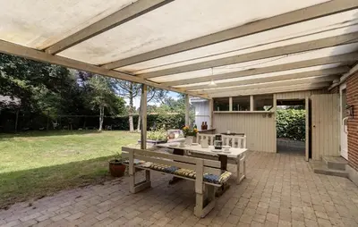 a pavilion with a table and a bench on a patio at Pet Friendly Home In Farsø With House A Panoramic View in Farsø