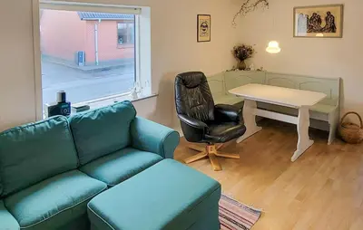 a living room with a couch and a table at Lovely Home In Karby With Wifi in Karby