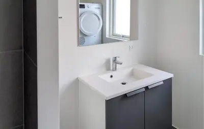 a bathroom with a sink and a mirror at 3 Bedroom Nice Home In Løgstrup in Løgstrup