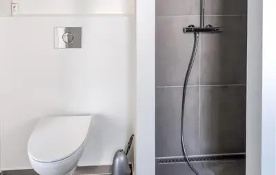 a bathroom with a toilet and a shower at 3 Bedroom Nice Home In Løgstrup in Løgstrup