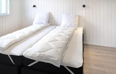 two beds with white sheets sitting in a room at 3 Bedroom Nice Home In Løgstrup in Løgstrup