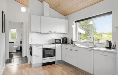 a kitchen with white cabinets and a sink at Nice Home In Fjerritslev With Sauna in Fjerritslev
