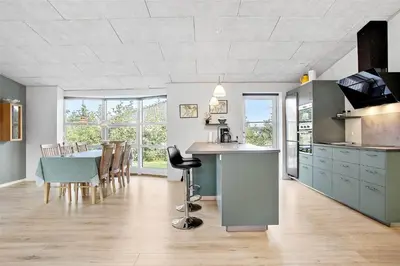 a kitchen and dining room with a table and chairs at JB130-Fjerritslev-Thorup-Strandvej-274 in Fjerritslev