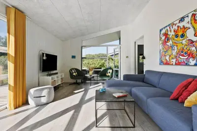 a living room with a blue couch and a tv at JB241-Fjerritslev-Lyngstien-25 in Fjerritslev