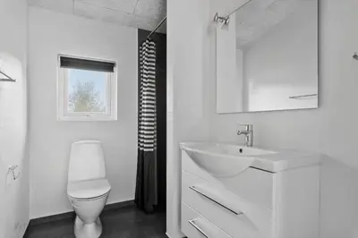a white bathroom with a sink and a toilet at JB241-Fjerritslev-Lyngstien-25 in Fjerritslev