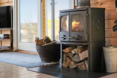 a stove in a room with a pile of wood at JB356-Frostrup-Horsbakkevej-6 in Frøstrup