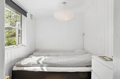 a bed in a room with a window at JB323-Fjerritslev-Markstien-21 in Fjerritslev