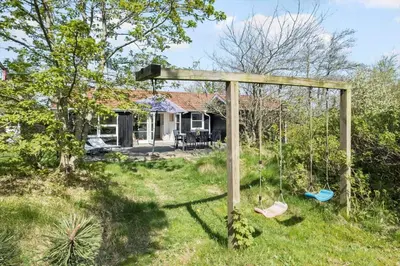 a house with a swing in the yard at JB323-Fjerritslev-Markstien-21 in Fjerritslev