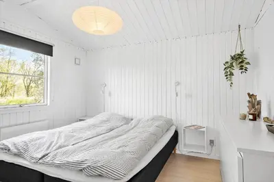 a white bedroom with a bed and a desk at JB323-Fjerritslev-Markstien-21 in Fjerritslev