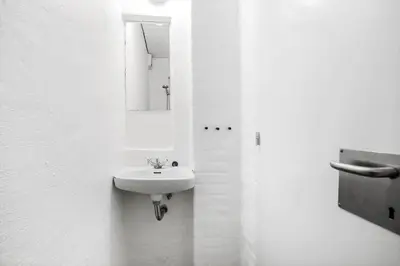 a white bathroom with a sink and a mirror at JB181-Brovst-Strandvejen-150-Lejl-142 in Brovst