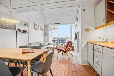 a kitchen and living room with a table and chairs at JB181-Brovst-Strandvejen-150-Lejl-142 in Brovst