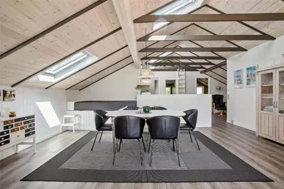 a dining room with a table and black chairs at JB578-Fjerritslev-Hasselvej-57 in Fjerritslev