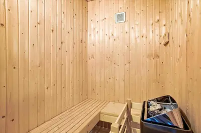 a sauna with a wooden wall and a tub at JB578-Fjerritslev-Hasselvej-57 in Fjerritslev
