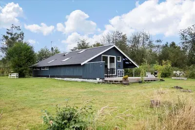 a black house with a solar roof on a field at JB578-Fjerritslev-Hasselvej-57 in Fjerritslev