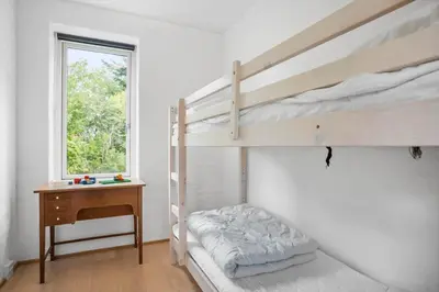 a bedroom with two bunk beds and a desk at JB1031-Fjerritslev-Thorup-Strandvej-266 in Fjerritslev