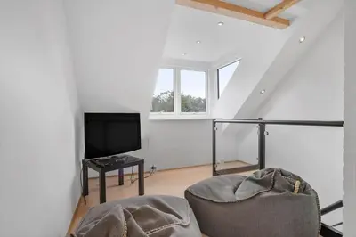a living room with a tv and a chair at JB1031-Fjerritslev-Thorup-Strandvej-266 in Fjerritslev