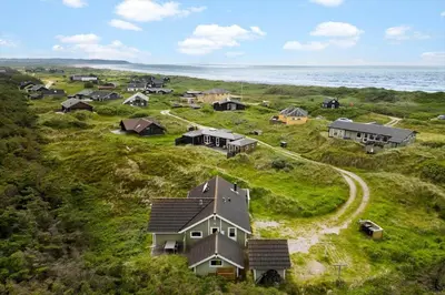 an aerial view of a house on a hill near the ocean at JB765-Brovst-Sletten-20 in Brovst