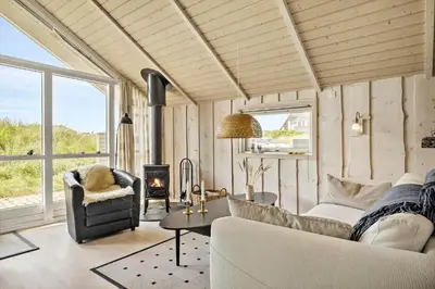 a living room with a couch and a table at JB765-Brovst-Sletten-20 in Brovst