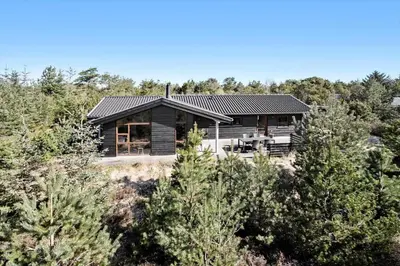 a wooden house in the middle of a forest at JB193-Fjerritslev-Blabaerstien-78 in Fjerritslev