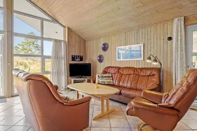 a living room with a leather couch and a table at JB290-Fjerritslev-Mollebosletten-41 in Fjerritslev