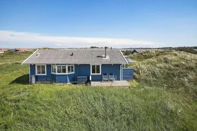 a blue house sitting in the middle of a field at JB183-Frostrup-Svenstibakkevej-70 in Frøstrup