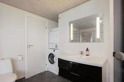 a bathroom with a sink and a washing machine at JB326-Brovst-Kronvildtvej-134 in Brovst