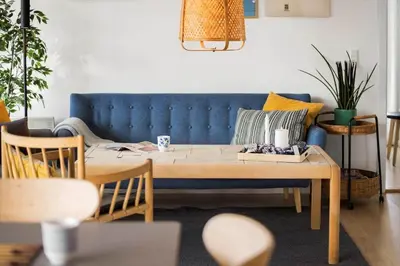 a living room with a blue couch and a table at JB307-Brovst-Kronvildtvej-130 in Brovst
