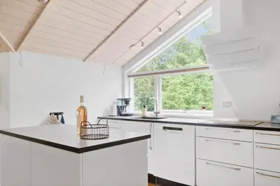 a kitchen with white cabinets and a large window at JB901-Aabybro-Graanden-40 in Åbybro