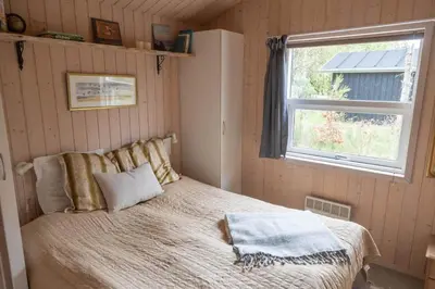 a bedroom with a bed and a window in it at JB827-Fjerritslev-Revlingestien-93 in Fjerritslev