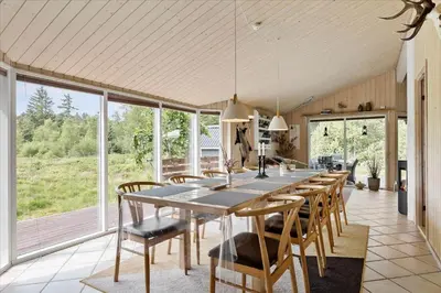 a dining room with a large table and chairs at JB827-Fjerritslev-Revlingestien-93 in Fjerritslev