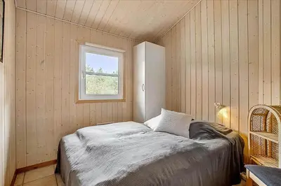 a small bedroom with a bed and a window at JB699-Fjerritslev-Revlingestien-43 in Fjerritslev