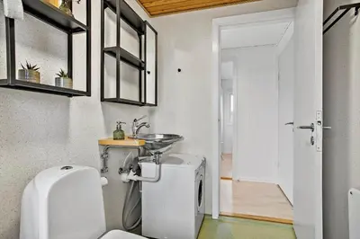 a bathroom with a toilet and a sink in it at JB155-Frostrup-Svenstibakkevej-5 in Frøstrup