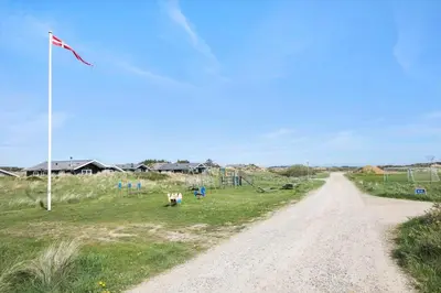a dirt road next to a field with a kite at JB155-Frostrup-Svenstibakkevej-5 in Frøstrup