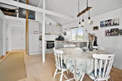 a kitchen with a table and chairs in a room at JB155-Frostrup-Svenstibakkevej-5 in Frøstrup