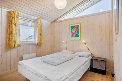 a bedroom with a large bed in a room with a window at JB340-Frostrup-Krinkelkrogen-14 in Frøstrup