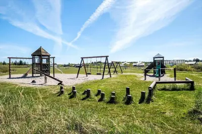 an empty playground with two swings in a field at JB225-Brovst-Kronvildtvej-218 in Brovst