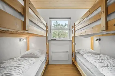 two bunk beds in a room with a window at JB225-Brovst-Kronvildtvej-218 in Brovst