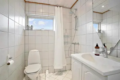 a bathroom with a toilet and a sink and a shower at JB163-Brovst-Ejstrup-Strandvej-32 in Brovst