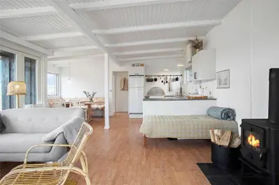 a living room with a couch and a stove at JB163-Brovst-Ejstrup-Strandvej-32 in Brovst