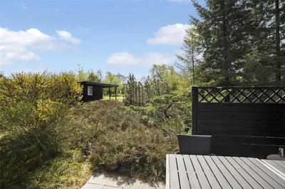 a garden with a bench and a gazebo at JB988-Fjerritslev-Skovstien-6 in Fjerritslev