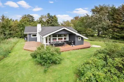 a small house with a deck in a yard at JB818-Fjerritslev-Ronnevej-20 in Fjerritslev