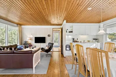 a living room and kitchen with a couch and a table at JB157-Brovst-Krogen-24 in Brovst