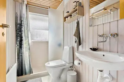 a small bathroom with a toilet and a sink at JB157-Brovst-Krogen-24 in Brovst