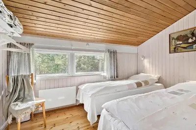 a bedroom with two beds and a wooden ceiling at JB157-Brovst-Krogen-24 in Brovst