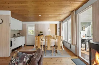 a kitchen and dining room with a table and chairs at JB157-Brovst-Krogen-24 in Brovst