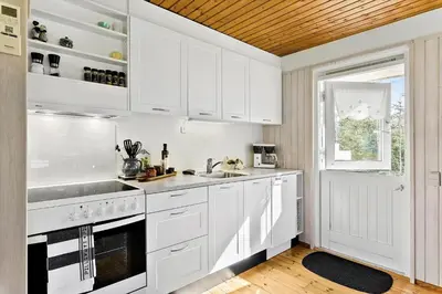 a white kitchen with white cabinets and a window at JB157-Brovst-Krogen-24 in Brovst